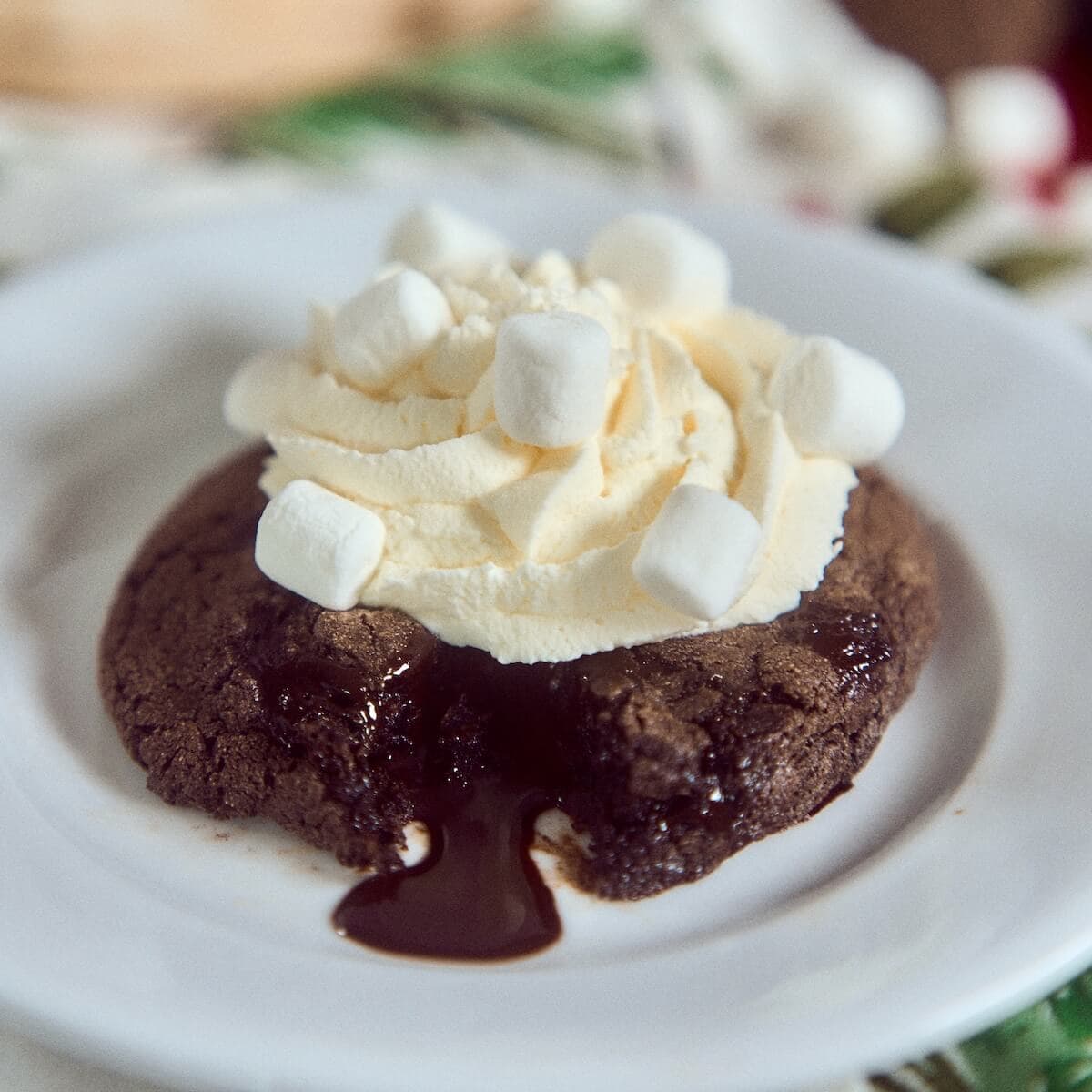 Hot Chocolate Lava Cookie on a white cake plate dripping fudge.